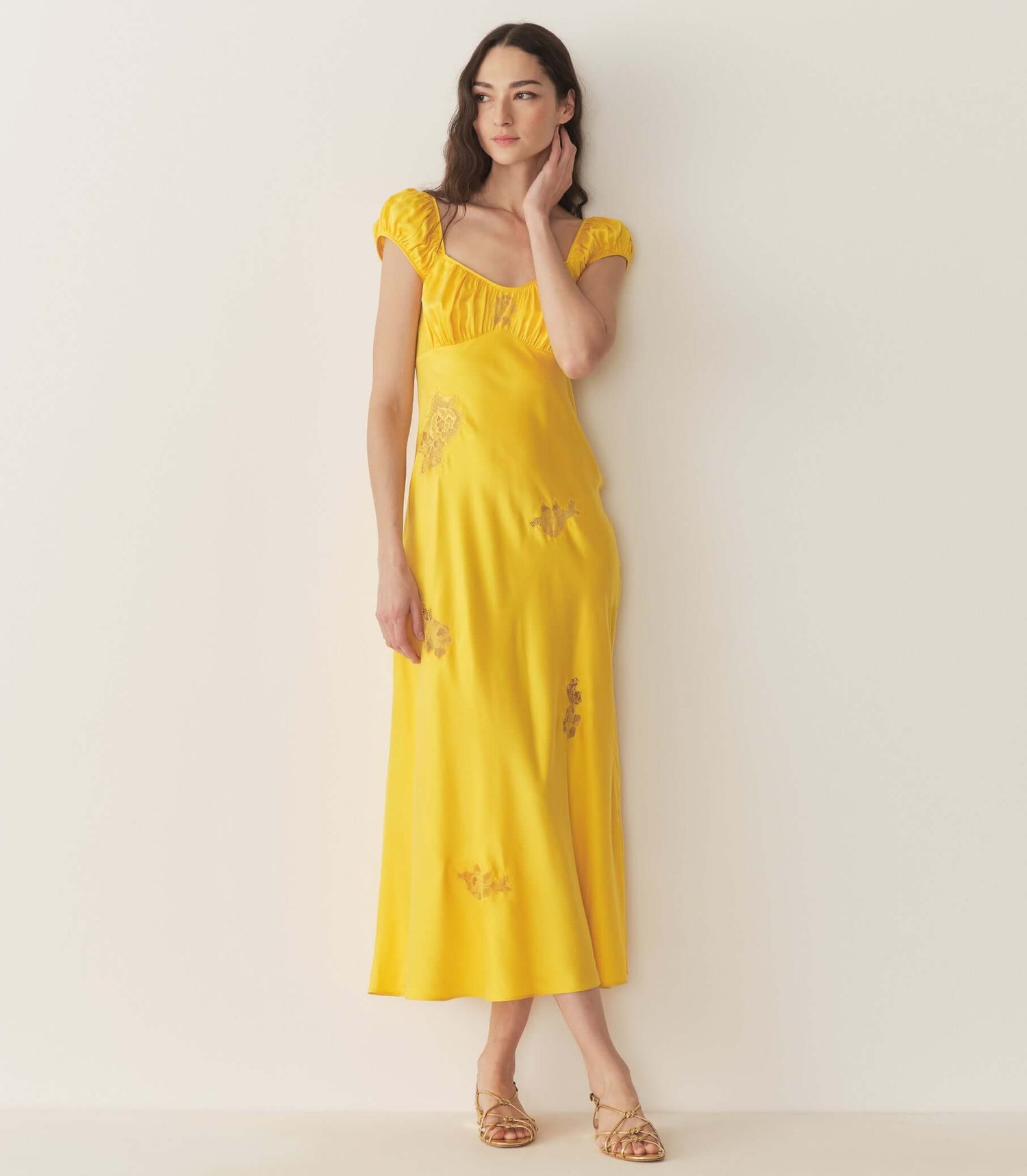 Stylish yellow dress with puff sleeves, perfect for summer occasions, featured in our dress collection.